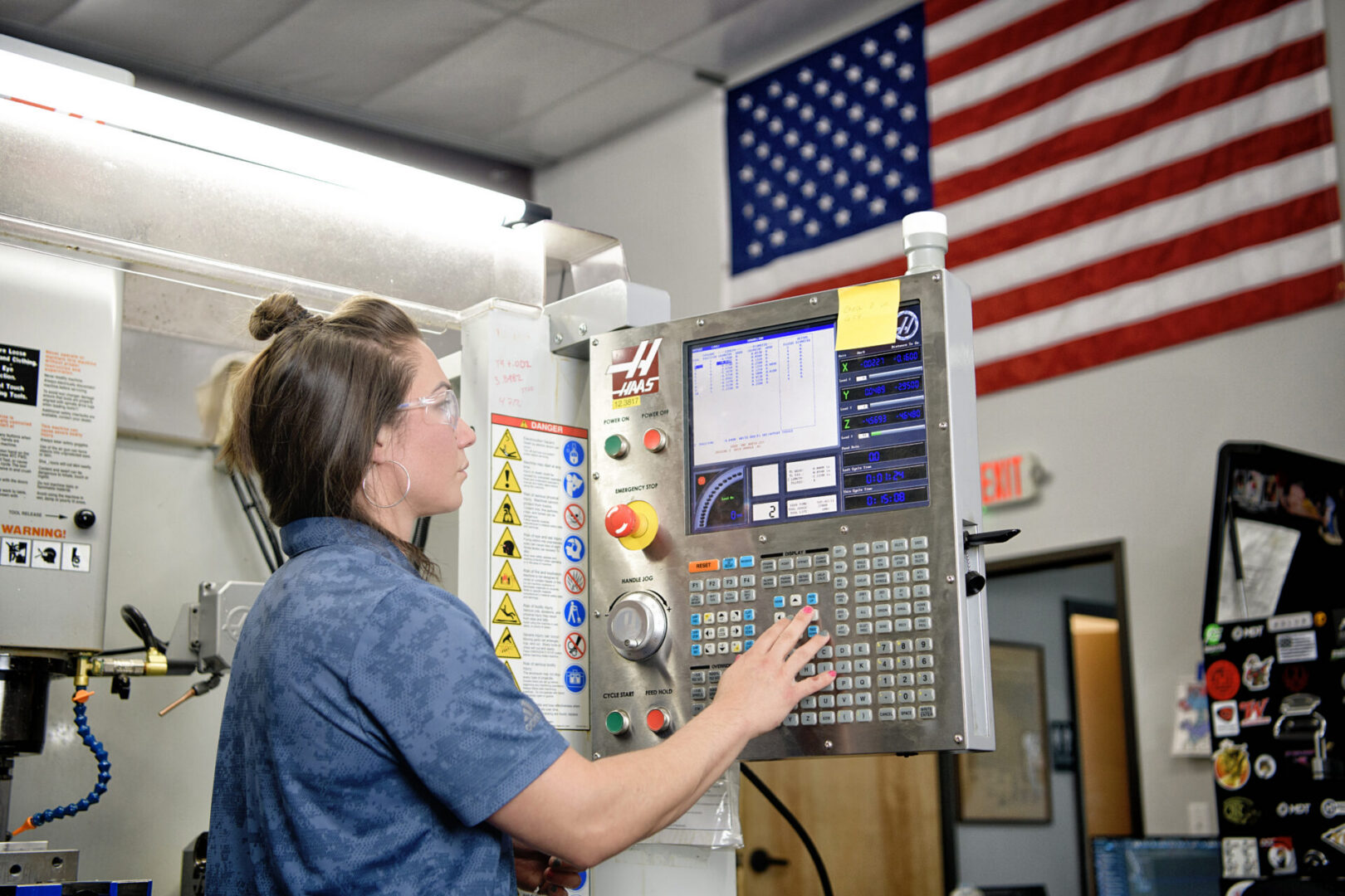 Engineer programming a CNC machining center for prototype manufacturing