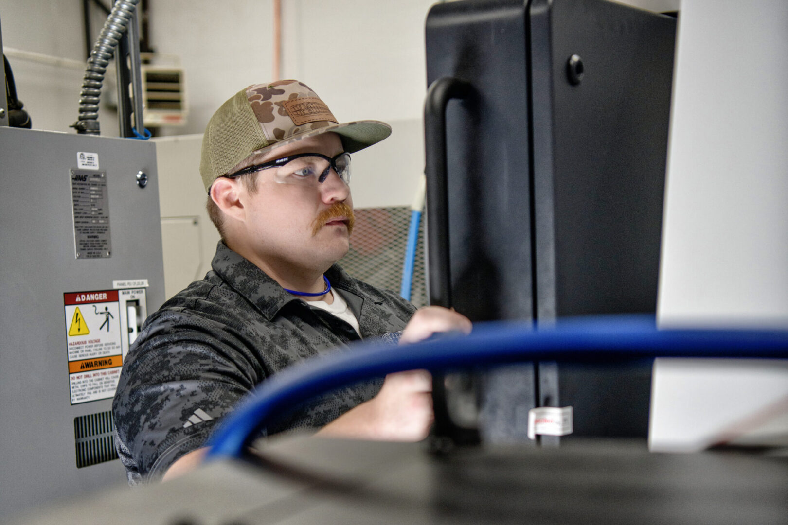 Lead Machinist Zach Brooks inspecting a precision-machined prototype component